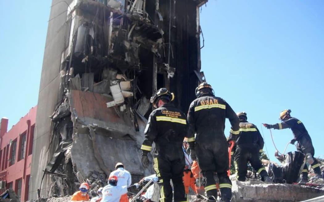 Rescue workers at the ruins of the CTV building.