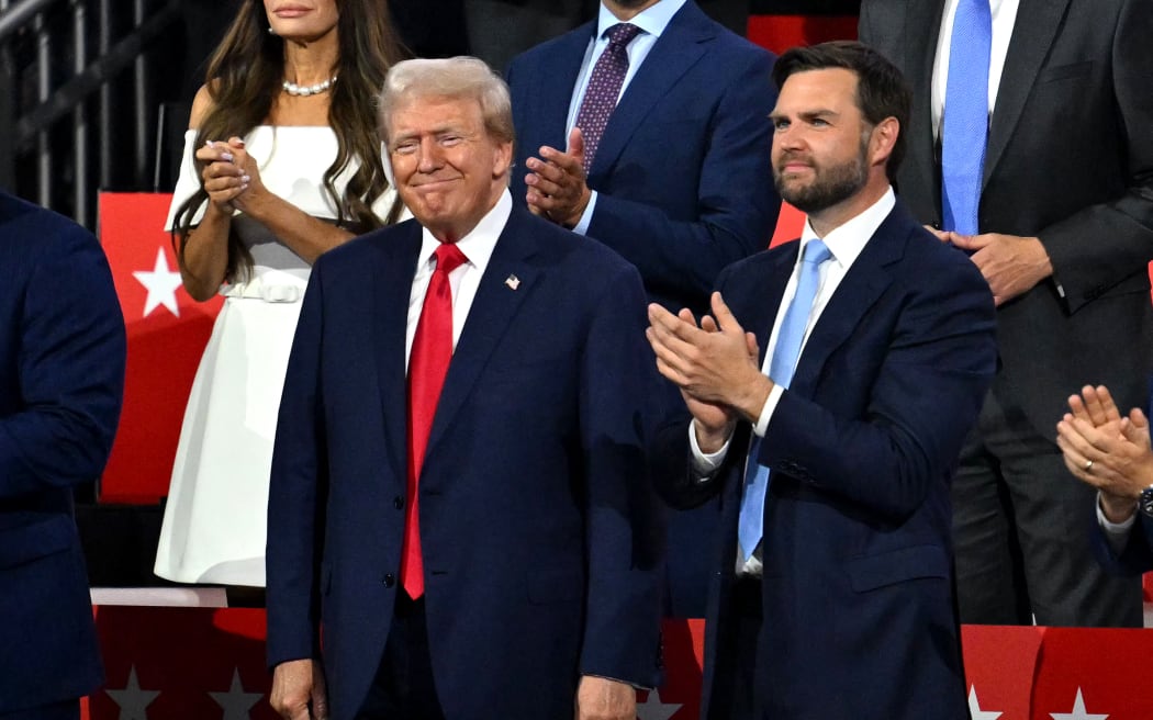 US former President and 2024 Republican presidential candidate Donald Trump (L) smiles next to US Senator from Ohio and 2024 Republican vice-president candidate J. D. Vance during the first day of the 2024 Republican National Convention at the Fiserv Forum in Milwaukee, Wisconsin, July 15, 2024.