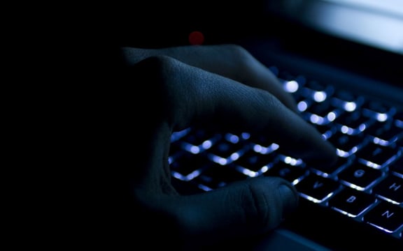 Hand on keyboard at night