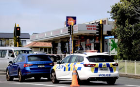 A police car outside the New Windsor dairy in Auckland.