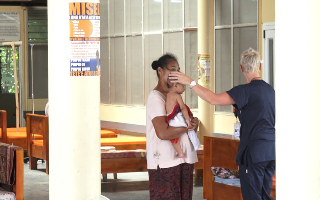 A baby who has measles at a clinic run by New Zealand doctors.