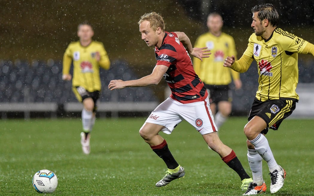 Mitch Nichols carries the ball while playing for the Western Sydney Wanderers against the Phoenix in 2016.
