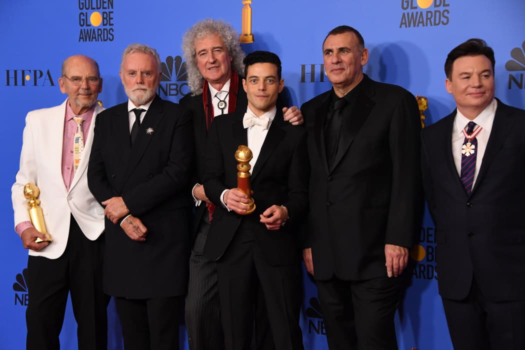 Bohemian Rhapsody winner Rami Malek poses with Graham King (second from right), Brian May (third from left) and Mike Myers (far right) during the 76th annual Golden Globe Awards.