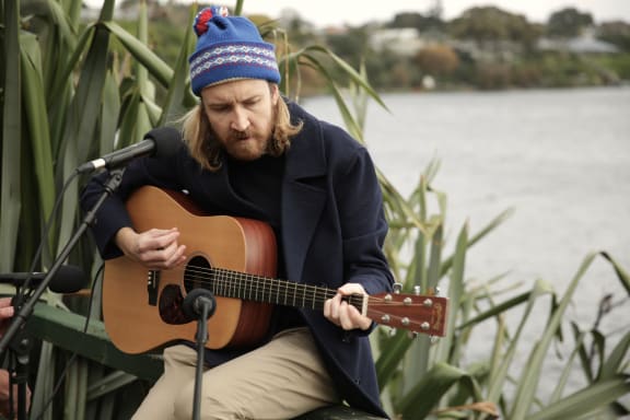 Lawrence Arabia (James Milne) performs next to Lake Pupuke.
