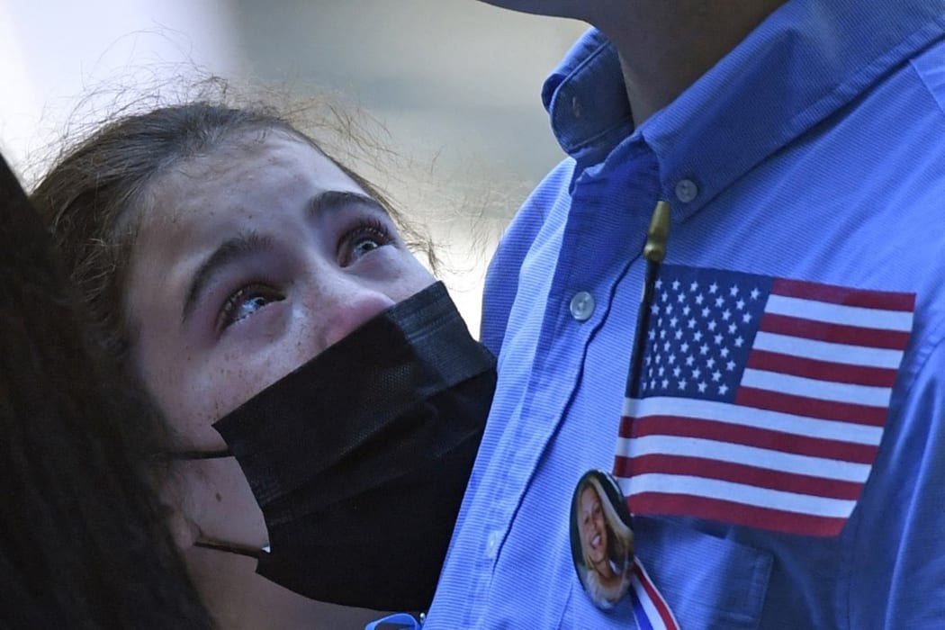 A family member grieves at the National 9/11 Memorial and Museum ceremony commemorating the 20th anniversary of the 9/11 attacks on the World Trade Center, in New York, on September 11, 2021.