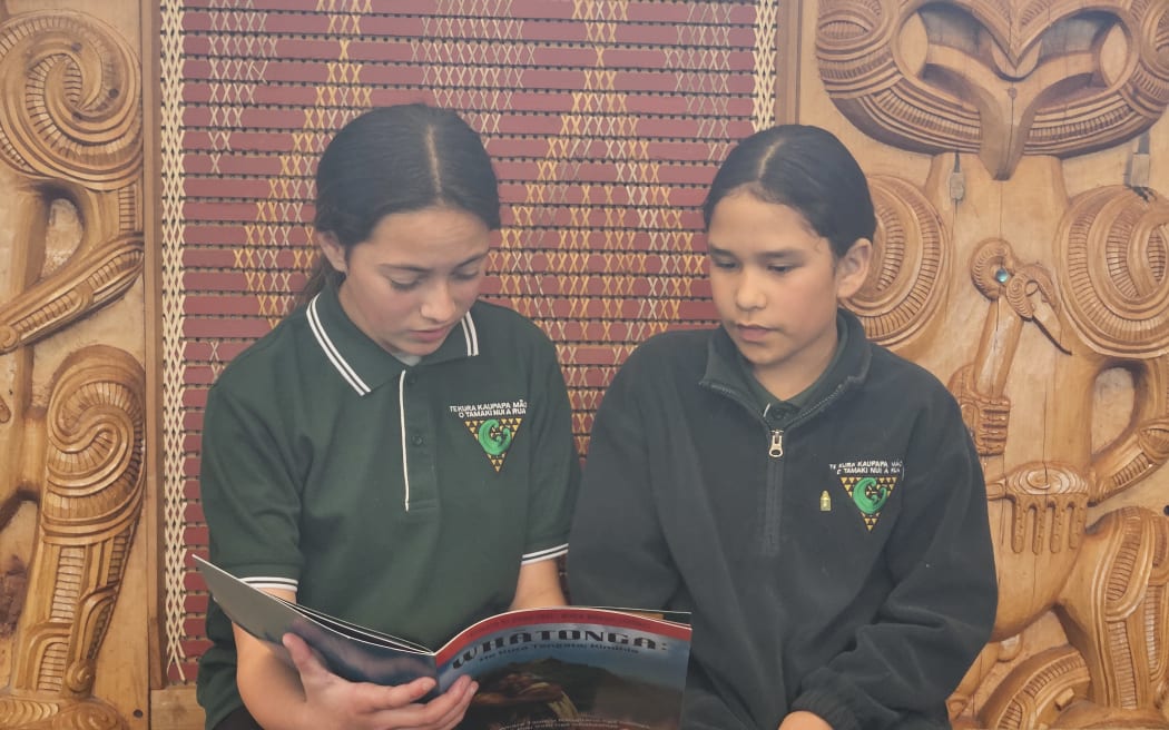 Kobe (left) and Cresha (right) reading Whātonga: In search of man, for the first time.