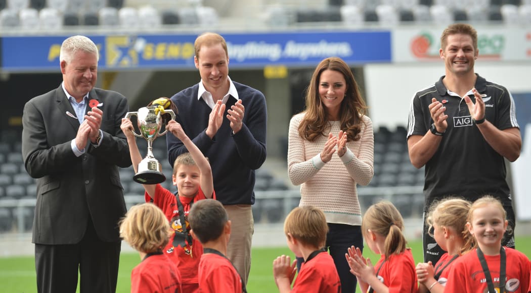 Clutha captain Henry Craig holds up the cup in front of NZRFU head Steve Tew (left), Prince William, Catherine and All Black captain Richie McCaw..