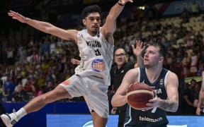 New Zealand’s Shea Ili tries to guard Slovenia’s Luka Doncic in their FIBA 2024 Olympic qualifying tournament basketball match in Athens.