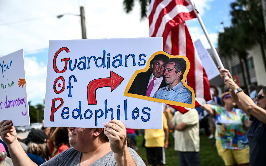 People participate in a "No Kings" national day of protest in West Palm Beach, Florida, on October 18, 2025. From New York to San Francisco, millions of Americans are expected to hit the streets to voice their anger over President Donald Trump's policies at nationwide "No Kings" protests. (Photo by CHANDAN KHANNA / AFP)