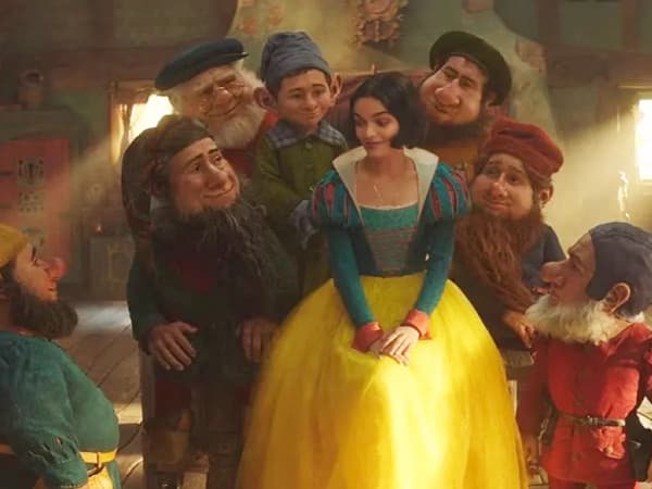 Seven CG-animated dwarfs hover around Snow White.