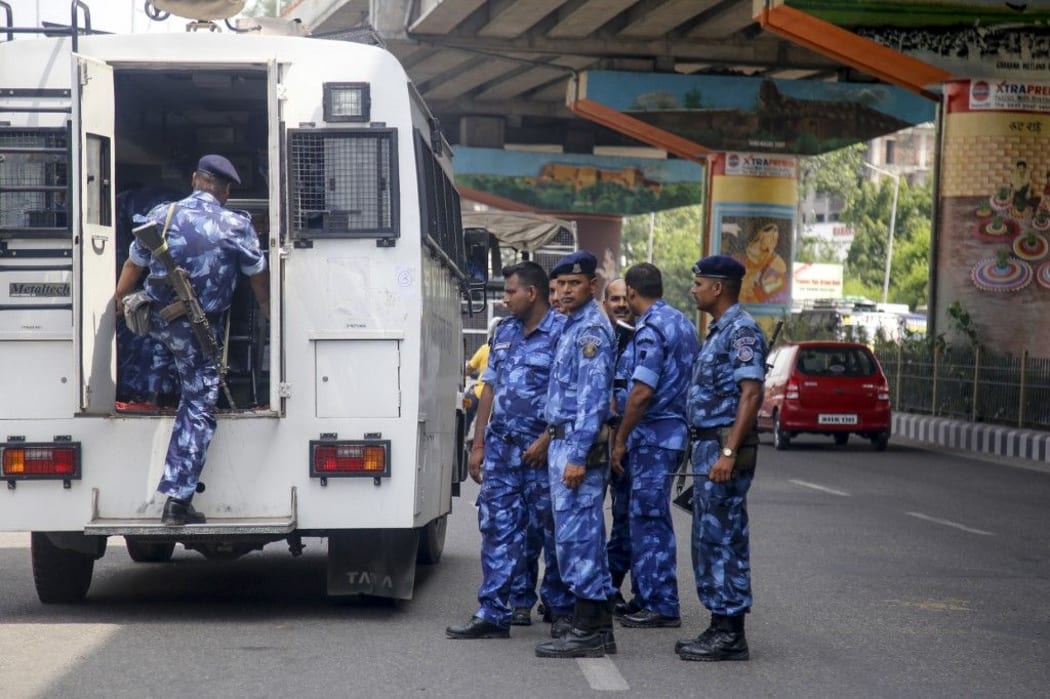 Rapid Action Force personnel look on as they arrive in Kashmir, after security measures have been reinforced, in Jammu on August 3, 2019.