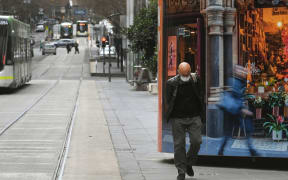 A pedestrian walks along a deserted Burke Steet Mall in Melbourne's central business district on 2 September, 2020.