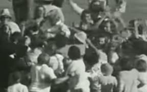 When he reached his century, members of the crowd ran on and jostled and hoisted Redmond.