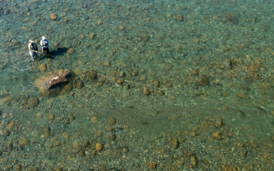 A participant in Reel Recovery and his fishing guide take on the mighty waters of the Tongariro River, near Turangi.