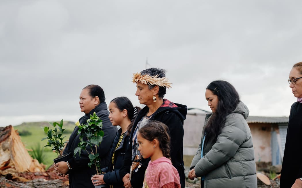 Christine and Salome Nurminen, Therese Mangos, Taiaaria Mackenzie and Maria Tanner wait for the call of the whakatau before entering Ihumātao.