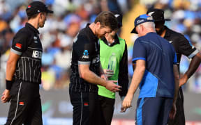 New Zealand's Jimmy Neesham injured while fielding off his own bowling during the ICC Cricket World Cup 2023