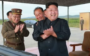 North Korean leader Kim Jong-Un (C) inspecting a launching drill of the medium-and-long range strategic ballistic rocket Hwasong-12.