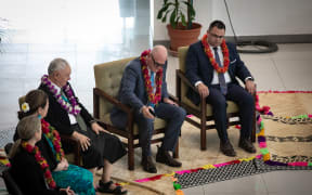 National MP Todd Muller tips a little ava on the custom mat as a sign of respect to the local community during an ava ceremony to welcome New Zealand MPs in Samoa, 11 July 2023. To his left is Labour MP Tangi Utikere and on his right, New Zealand's High Commissioner in Samoa, Trevor Matheson.