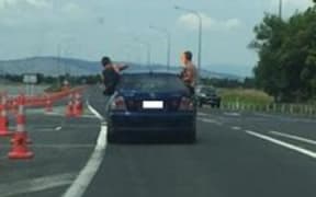 Two men door surfing.