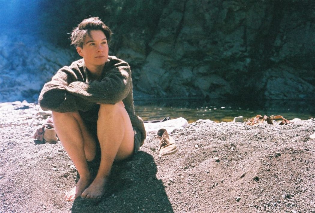 A photo of Sylvan Thomson by a river