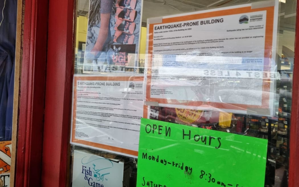 Notices warning dozens of Stratford buildings are earthquake prone have appeared in shop windows and on structures such as the towns famous glockenspeil.
