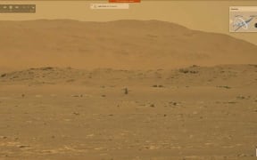 This video grab made from a NASA live stream on April 19, 2021 shows the agency's Ingenuity Mars Helicopter flying over the surface of Mars. - NASA successfully flew the Ingenuity helicopter on Mars on April 19, data downloaded from the aircraft confirmed.