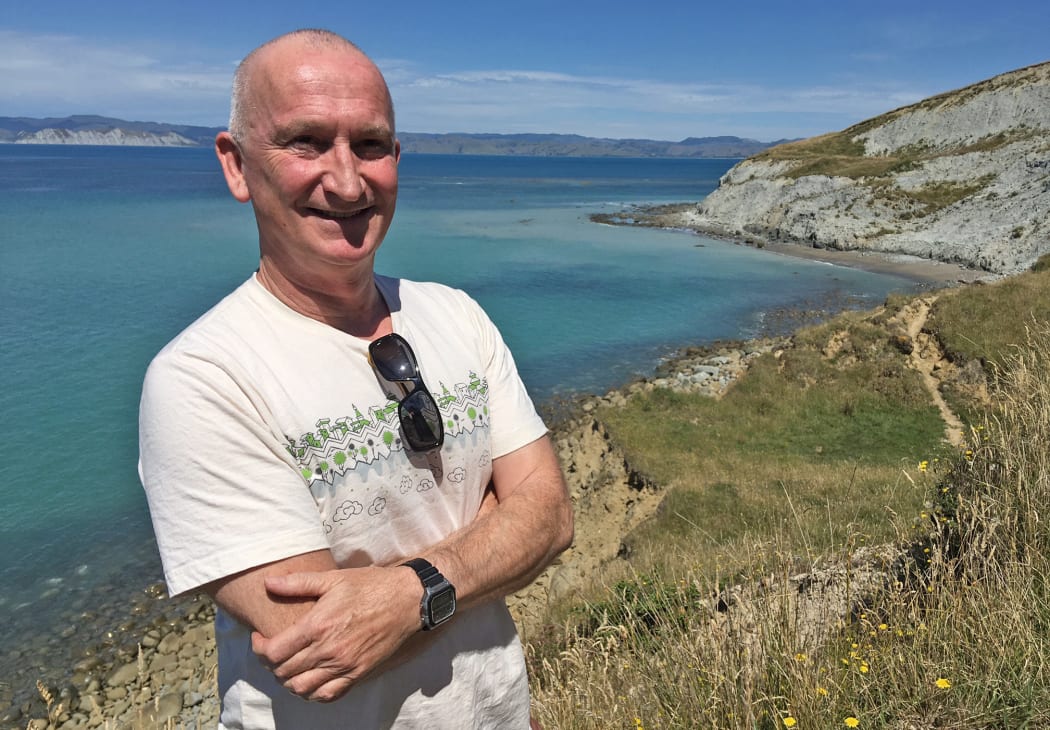 Martin Williams stands on the hill above Sponge Bay, Gisborne, where he was hit