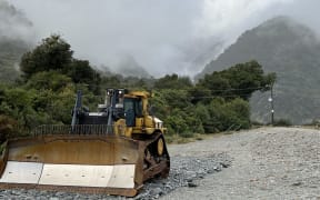 A D7 bulldozer sit waiting on the northern bank of the Waiho River close to the Franz Josef heliport.