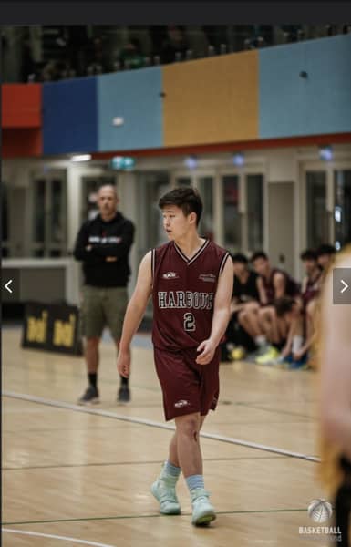 Pinehurst School student Kevin Guo playing basketball.