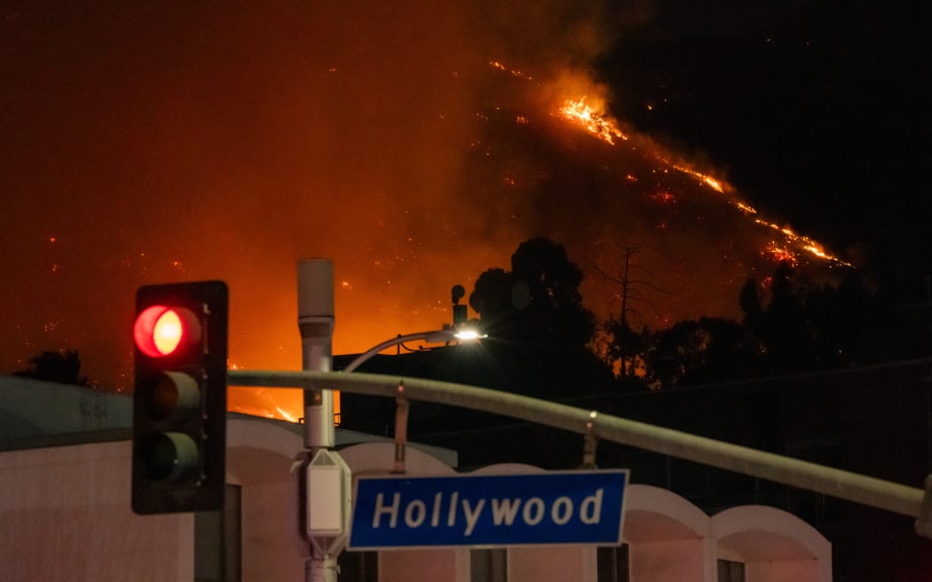 HOLLYWOOD, CA - JANUARY 08: Flames are seen on the hillsides above Hollywood Blvd. during the Sunset Fire on January 08, 2025 in Hollywood, California.  (Photo by AaronP/Bauer-Griffin/GC Images)