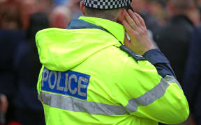 Police officer during Prince Harry's NZ tour.