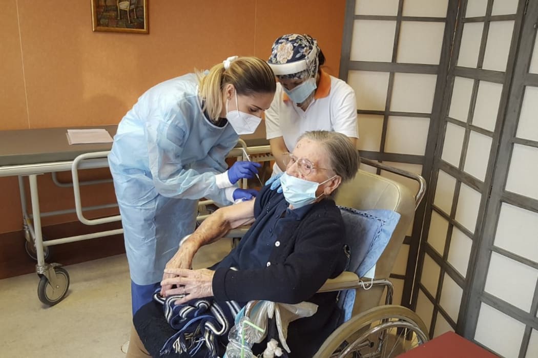 Italian healthcare Kos Group, shows the vaccination of 108-years-old Fatima Negrini, a resident at the group's Anni Azzurri San Faustino residence in Milan who tested positive in May 2020,  in Milan.