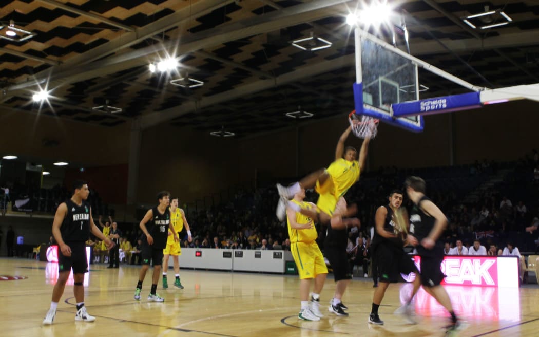 Australia's Dante Exum with the slam dunk during the 2012 Fiba U19 Oceania Championship - Junior Tall Blacks v Australian Emus at Te Rauparaha Arena, Porirua, New Zealand on Thursday 20 September 2012. Photo: Justin Arthur / photosport.co.nz