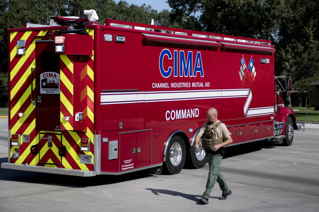 A Harris County Sheriff walks by a Channel Industries Mutual Aid firetruck at the Crosby volunteer fire department after a chemical plant operated by the Arkema Group had an explosion during the aftermath of Hurricane Harvey on August 31, 2017 in Crosby, Texas.