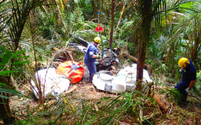 Investigators remove the wreckage of a Robinson R44 helicopter in Glenbervie forest near Whangarei.