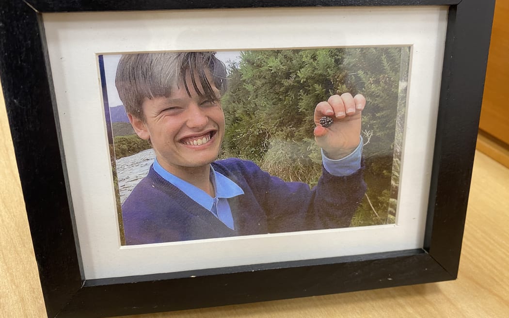 Sincere Standtrue, in the picture smiling while collecting blackberries. The picture is one of his three family placed in the courtroom on the first day of investigation on his death.