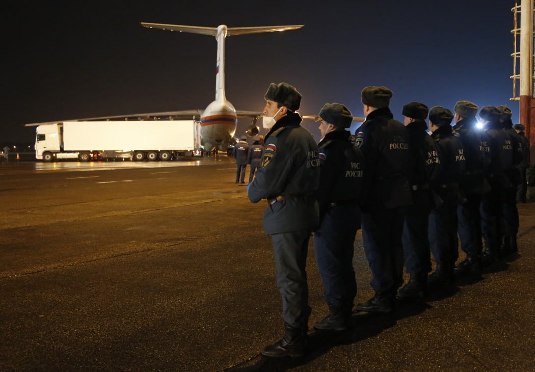 Russian Ministry for Emergency Situations employees prepare to load the bodies of the victims from the ministry's plane at the airport in St Petersburg.