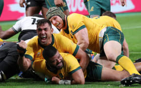 Australia's Tolu Latu celebrates after scoring one of his tries during the second half of the match against Fiji at the Rugby World Cup.