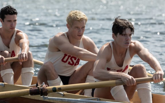 (l-r.) Bruce Herbelin-Earle stars as Shorty Hunt, Callum Turner as Joe Rantz and Jack Mulhern as Don Hume in director George Clooney’s THE BOYS IN THE BOAT. An Amazon MGM Studios film. Photo credit: Laurie Sparham. © 2023 Metro-Goldwyn-Mayer Pictures Inc. All Rights Reserved.