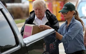 US President Donald Trump and first lady Melania Trump help load emergency supplies while visiting Texas.