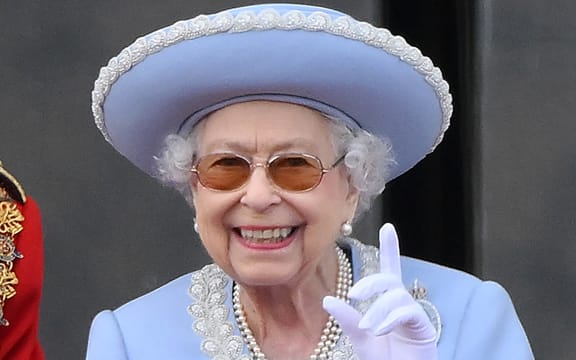 Britain's Queen Elizabeth II reacts as she watches a special flypast from Buckingham Palace balcony following the Queen's Birthday Parade, the Trooping the Colour, as part of Queen Elizabeth II's platinum jubilee celebrations, in London on June 2, 2022. - Huge crowds converged on central London in bright sunshine on Thursday for the start of four days of public events to mark Queen Elizabeth II's historic Platinum Jubilee, in what could be the last major public event of her long reign. (Photo by Daniel LEAL / AFP)