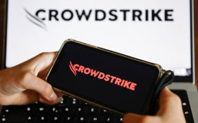 This photograph shows screens displaying logos of "CrowdStrike" cybersecurity technology company in Munich on July 19, 2024, amid massive global IT outage. Airlines, banks, TV channels and other business across the globe were scrambling to deal with one of the biggest IT crashes in recent years on July 19, 2024, caused by an update to an antivirus program. (Photo by Michaela STACHE / AFP)