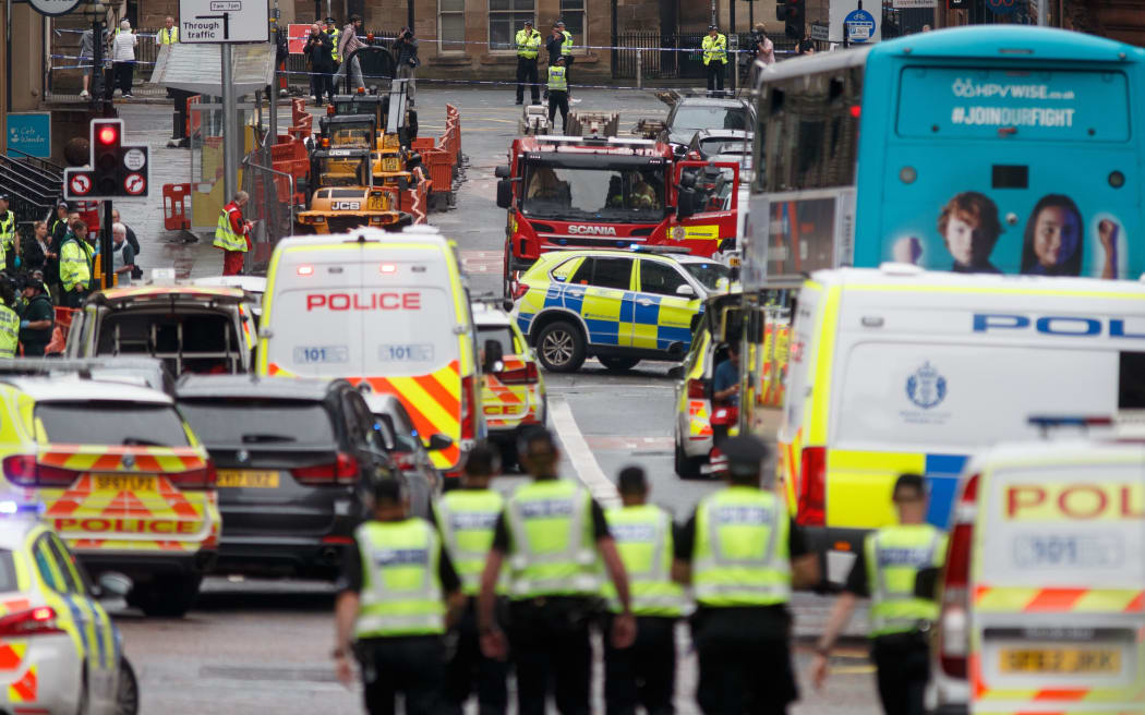 Police and emergency services respond at the scene of a fatal stabbing incident at the Park Inn Hotel in central Glasgow on June 26, 2020.
