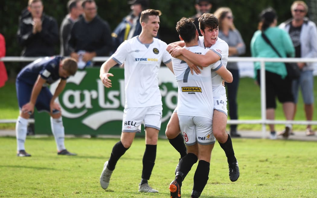 Wellington players Jack-Henry Sinclair and Eric Molloy celebrate at the final whistle.