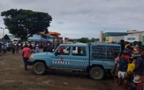 Police contain the crowd gathered at Boroka police station.