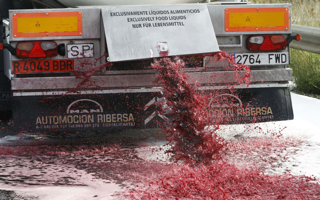 Wine flows from the tap of a Spanish truck's tanker on 4 April in France near the Spanish border during a demonstration of French winemakers against southern countries' wine imports.