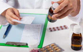 Horizontal view of pharmacist working in pharmacy