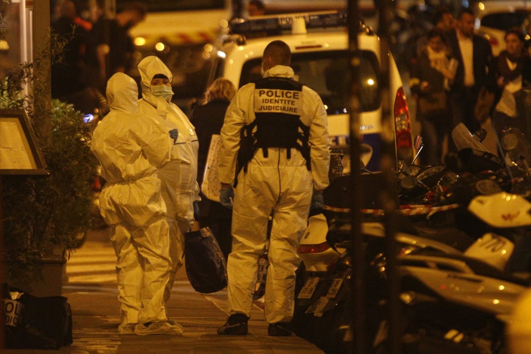 Forensic officers get ready as they arrive to inspect the area in Monsigny street in Paris centre after one person was killed and several injured by a man armed with a knife, who was shot dead by police in Paris.