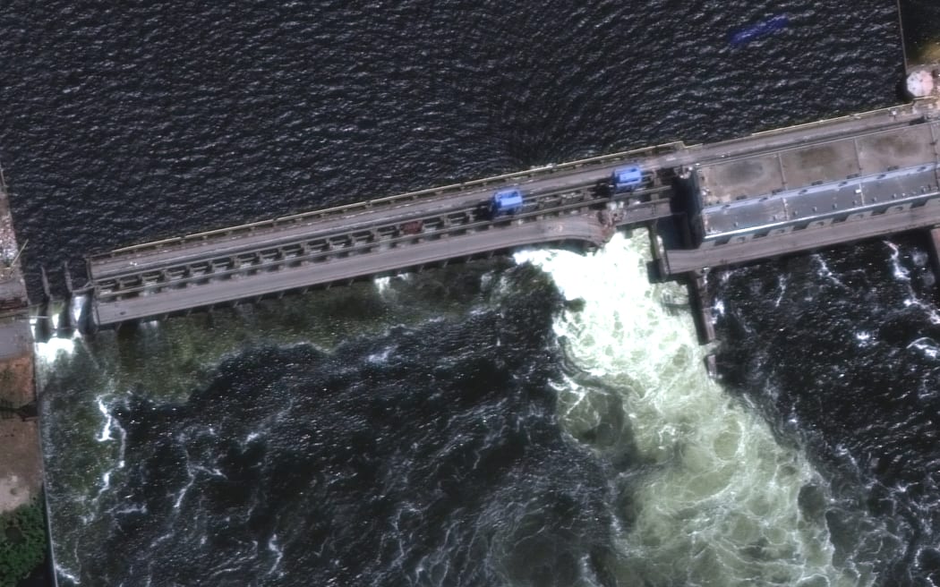 A satellite image shows a roadway and section of Nova Khakovka dam in south Ukraine. Ukrainian President Volodymyr Zelensky will urgently convene his Security Council on June 6, 2023 after an explosion at the Kakhovka hydroelectric dam in the south of the country.