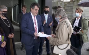 National MP Chris Bishop receives the Grounded Kiwis petition at Parliament.